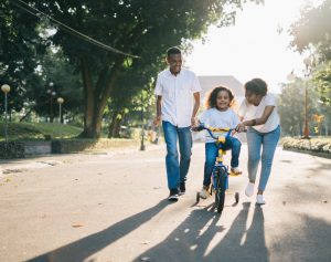 parents-with-kid-on-bike-300x237